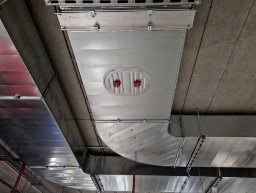 HVAC zone damper installed inside a metal air duct system.